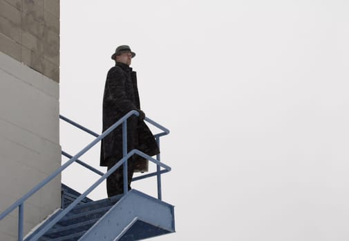 Lone man standing on an outdoor staircase