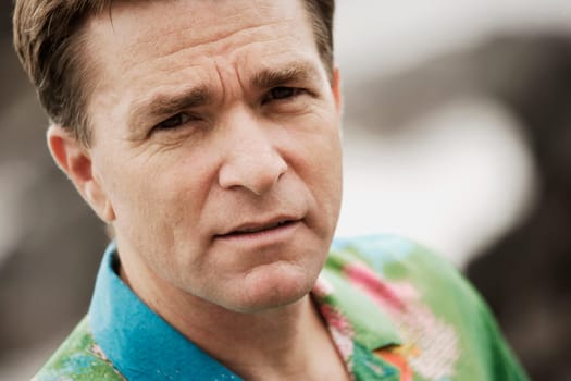 Close-up of man in bright shirt