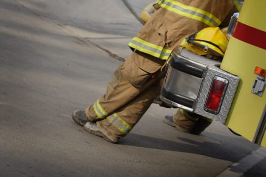 Firemen leaning against fire truck