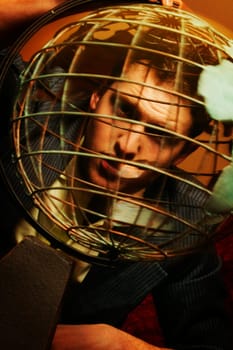 Man looking through metal globe