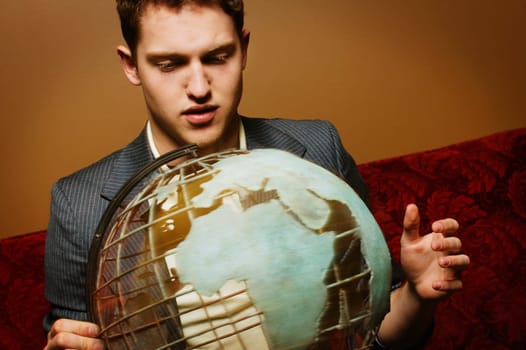 Businessman looking at a globe
