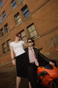 Fashionable couple and mini motorcycle