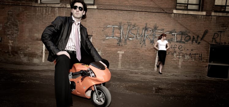 Urban couple and small bike