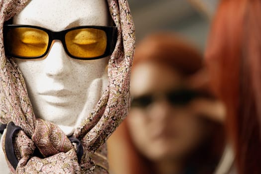 Mannequin head modeling sunglasses and scarf