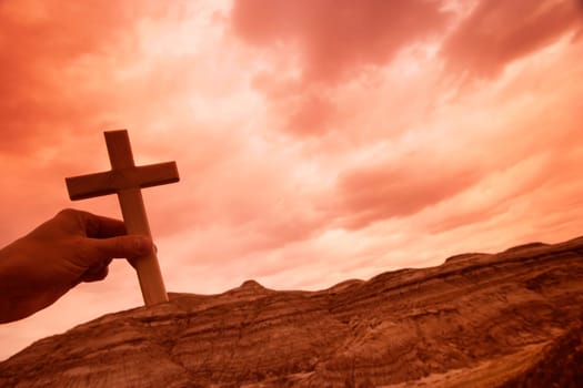 Hand holding a cross