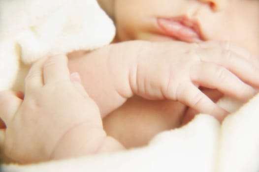 Portrait of a newborn's hands and mouth