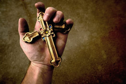 Broken cross in hand