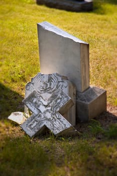 Broken headstone in cemetery