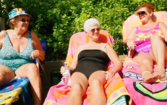 Group of three women sunbathing