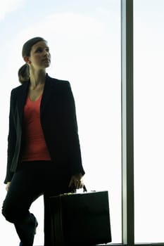 A business woman in front of a window