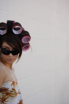A woman with curlers in her hair
