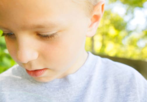 A young boy looking down