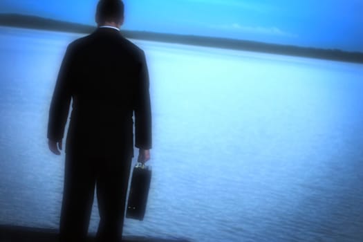 A man alone looking out over water