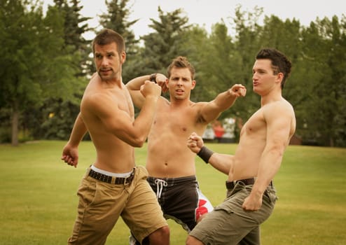 Group of young men practicing a mock fight