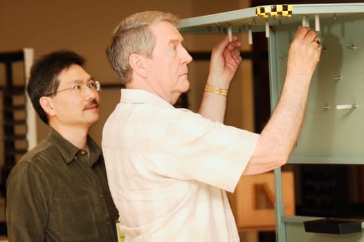 An occupational therapist working with a senior businessman