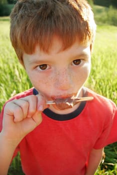 Boy eating ice lolly
