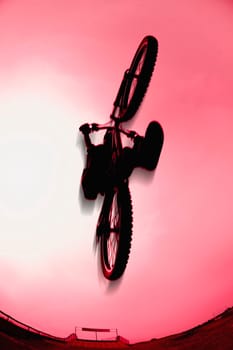 Silhouette stunt bike rider