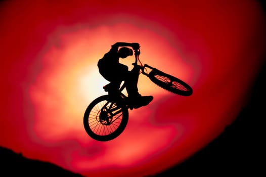 Silhouette of trick bike rider