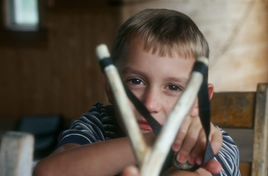 Child with sling shot