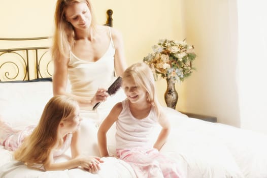 Mother brushing daughter's hair