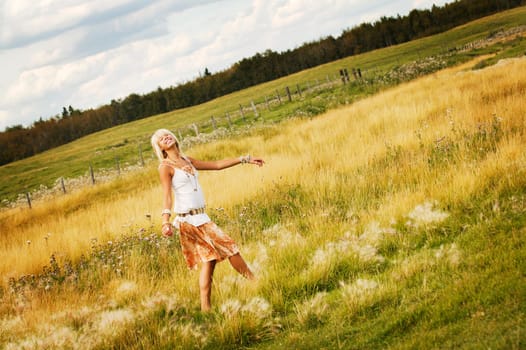 Teen girl walking through field