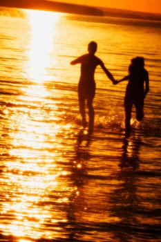 Couple hand in hand in water
