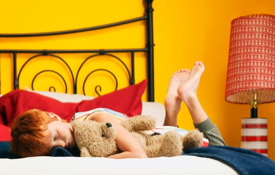 Child hugs teddy bear