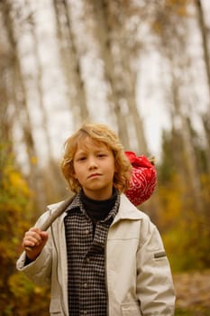 Young boy walking with pack