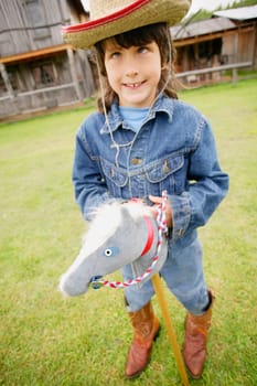 Child pretends to ride a horse