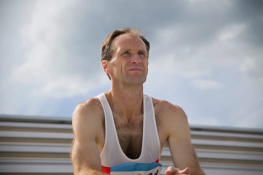 Athlete watches from the bleachers