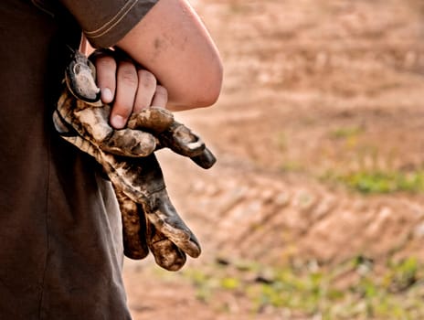 Man with worn gloves in hand