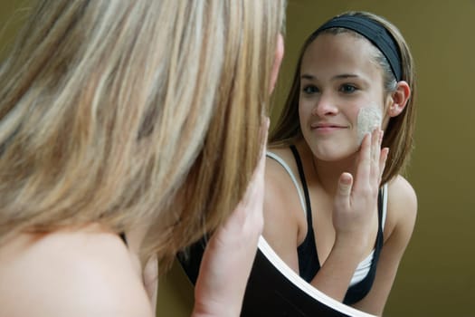 Applying facial moisturizer