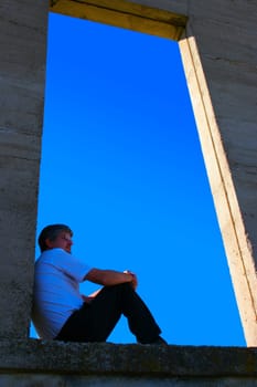 Man sitting on open ledge