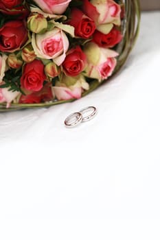 Wedding rings in front of bridal bouquet