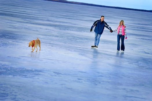 Couple skating on a frozen lake