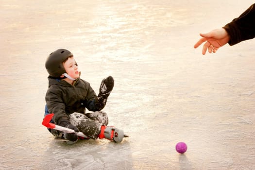 Boy needing help up from ice