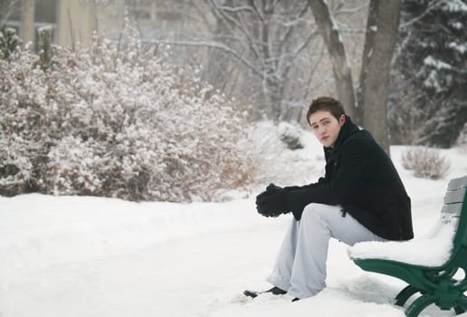 Sitting on a snowy bench