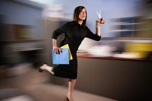 Woman runs with scissors through office
