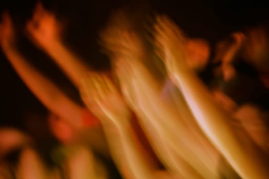 Hands raised at a concert