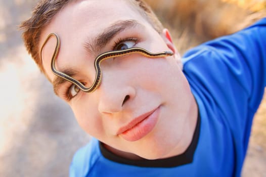Boy with snake on his face