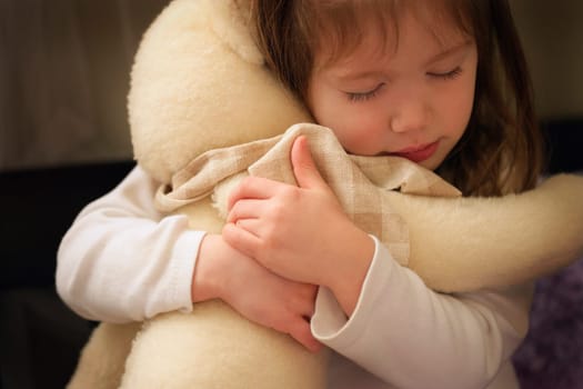 Child hugs bear