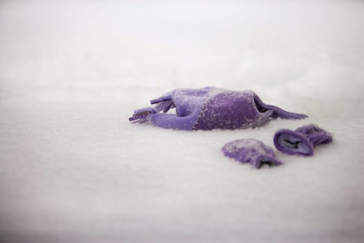Deserted hat and mittens on winter snow
