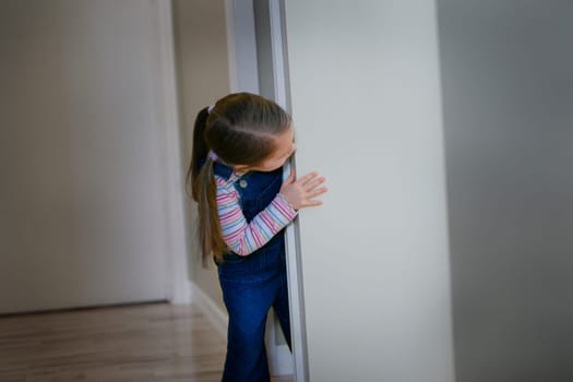 Child peeks around a corner