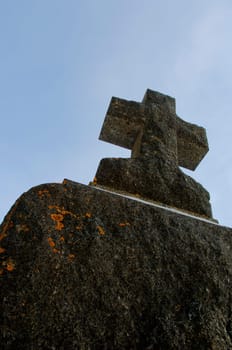An aged cross tombstone