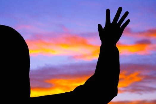 Silhouette of raised hand