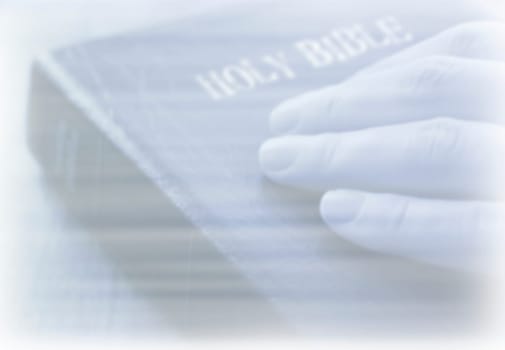 Hand on Bible Background