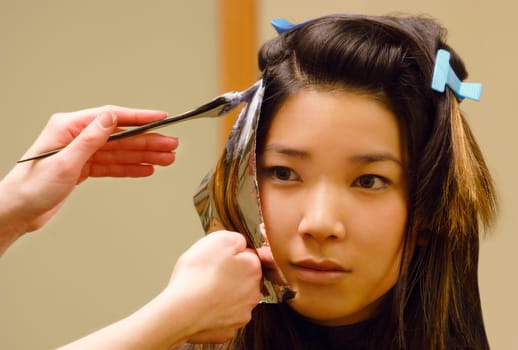 Closeup of woman getting hair foils