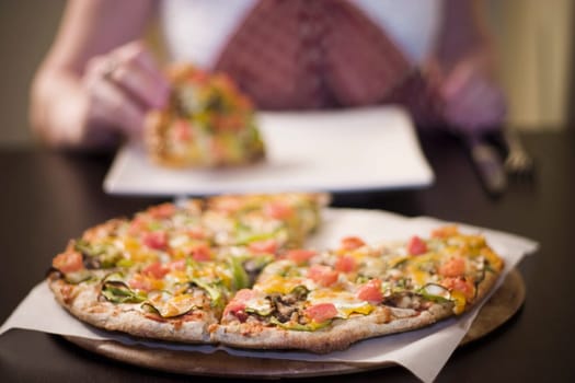 Woman eating pizza, front view