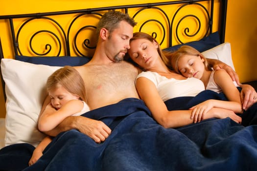A young family taking a nap