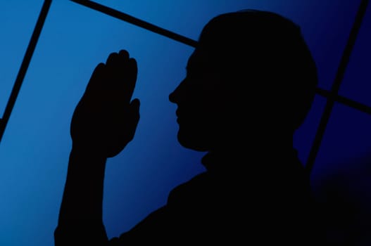 Silhouette of a man praying